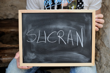 pizarra con la palabra gracias escrita en árabe, sucran