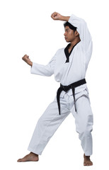Master Black Belt TaeKwonDo handsome man instructor Teacher fighter show hit pose, studio lighting white background isolated.  White formal fighting suit, motion blur hand foots on taekwondo post.