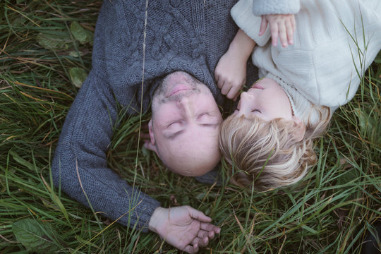 Father with son lying in meadow