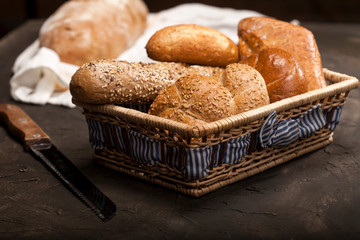 Assortment of baked goods in a basket on dark background