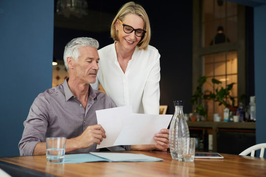 Mature couple with documents at home