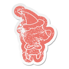 cartoon distressed sticker of a bear wearing santa hat