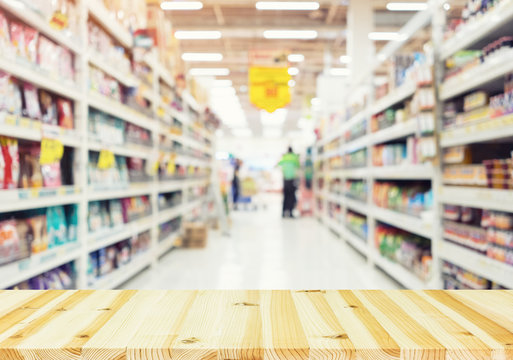 Supermarket or retail store blur background. That is a self-service shop offer grocery and variety of food, beverage and household product on shelf or rack. For shopping background or product display.