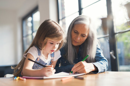 Grandmother and granddaughter making a drawing together