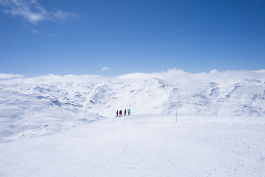 France, French Alps, Les Menuires, Trois Vallees, skiers enjoying view at distance