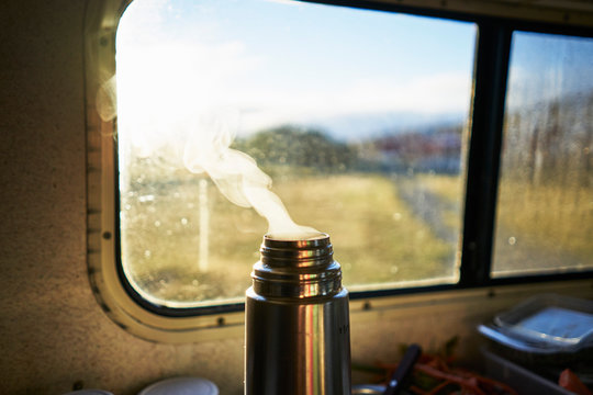 Steaming thermos flask in camper