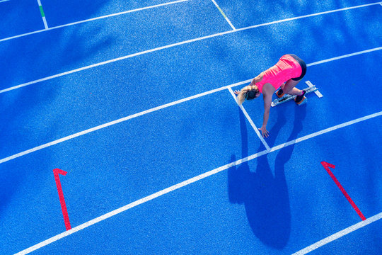 Top view of female runner in starting position