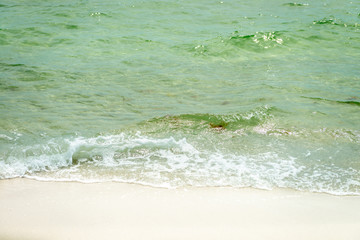 The surface of the beach water ripples