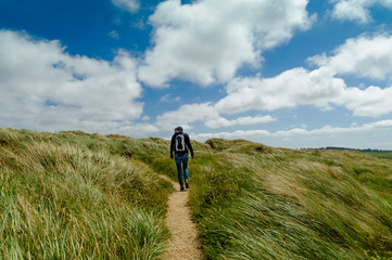 Denmark, Jutland, woman walking in dune landscape