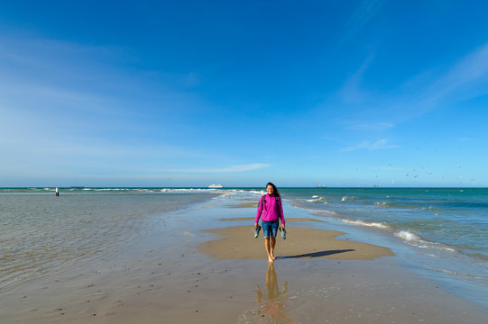 Denmark, Jutland, Skagen, Grenen, woman on the headland with North Sea and Baltic Sea