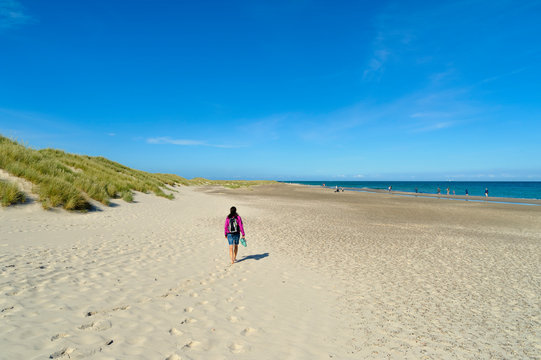 Denmark, Jutland, Skagen, Grenen, woman walking on the beach