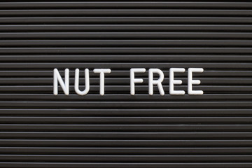 Black color felt letter board with white alphabet in word nut free background