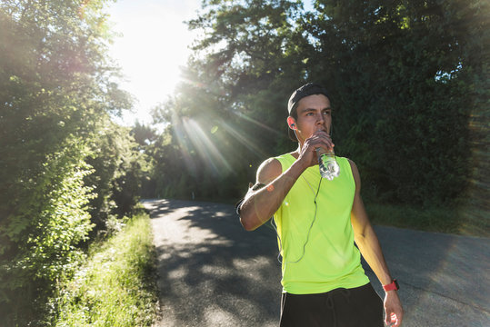 Jogger in the park drinking water
