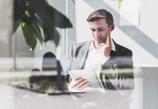 Businessman in office looking at tablet