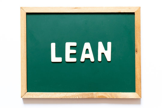 Green blackboard and wood frame with word lean on white background