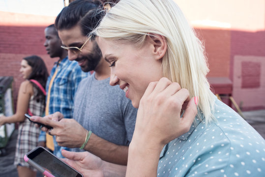 Young people using cell phones outdoors