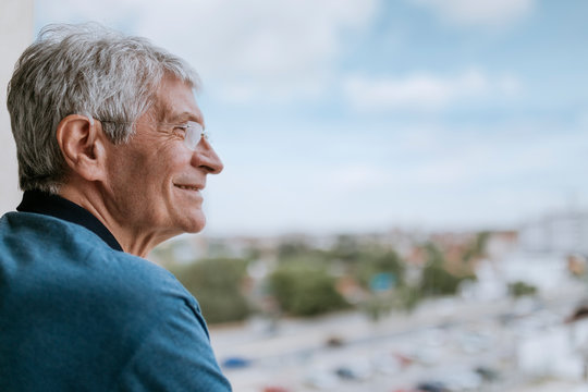 Smiling senior man with hearing aid outdoors