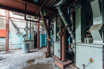 Fototapeta na wymiar Abandoned flour milling factory. Old rusty grain cleaning air separation machine 