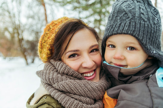 Portrait of mother and little son in the snow