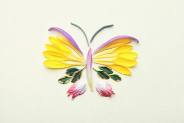 butterfly made of colorful flower petals and leaves, flat lay, top view