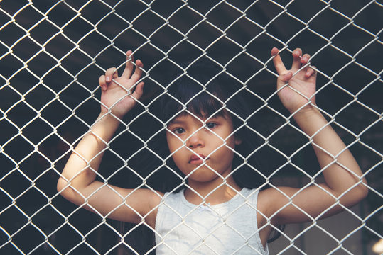  sad Asian girl child alone in cage was imprisoned make no freedom or lack of freedom