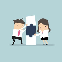 Businessman and businesswoman with puzzle box. Business and partnership concept.