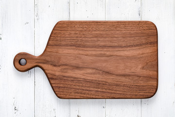 Handmade walnut chopping board on white wooden board top