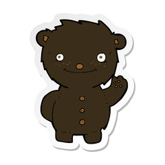 sticker of a cartoon waving black bear
