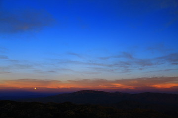 Fototapeta na wymiar Full moon coming up over the San Pedro river valley in the Coronado National Forest. 