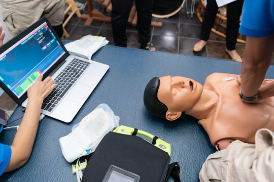 First aid training : automated external defibrilator and mannequin during an exercise of resuscitation with laptop process monitor (CPR).