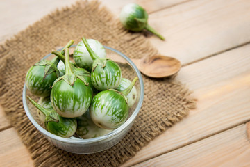 Raw organic eggplant in bowl 