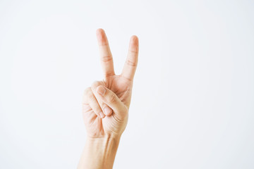 Man hand victory sign gesture on white background. Hand shows the number two.