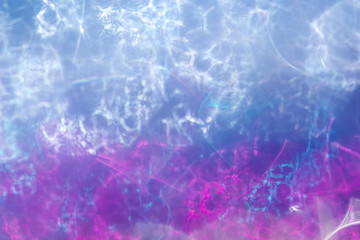Artsy contemporary abstract background with bokeh created by defocused lead crystal glass reflecting water-like colors of red, white, and blue