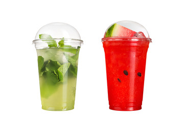 Delicious fruit smoothies in plastic cups, on a white background. Two mojito cocktails and...