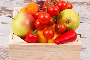 Fresh fruits and vegetables in wooden box. Food containing healthy minerals and vitamins