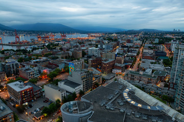Downtown Vancouver, British Columbia, Canada - June 22, 2018: Aerial view of the modern city during night time after a cloudy sunset.
