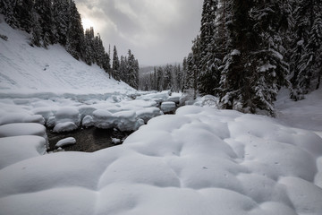 Beautiful Canadian Winter Landscape in the mountain valley during a cloudy day. Taken on a hike to Alexander Falls, Near Whistler and Squamish, North of Vancouver, BC, Canada.