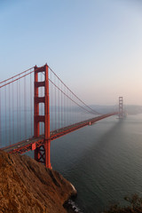 Beautiful view of Golden Gate Bridge during a hazy sunset. Taken in San Francisco, California, United States.
