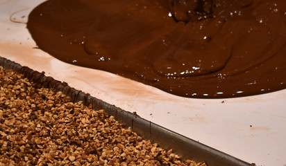 chocolate being poured next to almonds