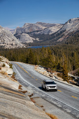 View of a scenic road, Tioga Pass, in the Valley surrounded by mountains. Taken in Yosemite National Park, California, United States.