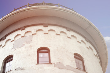 Lighthouse tower with Windows against blue sky.