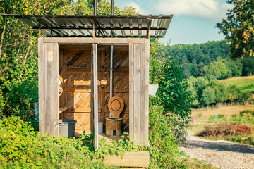 Wooden shed ecological composting toilet on countryside eco farm - Concept image