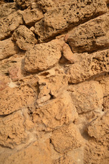 Fototapeta na wymiar Weathered sandstone block wall. Abstract background