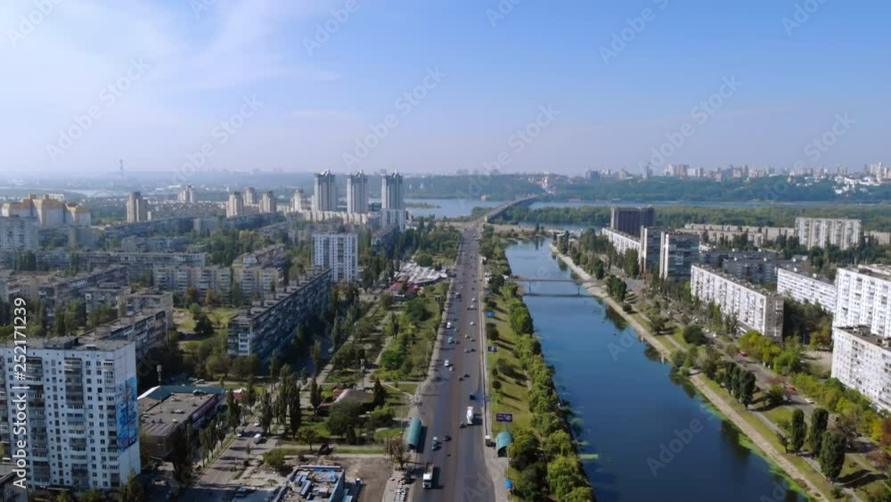 Poster aerial view on the city with river and trees in summer season. beautiful scene on right and left ban