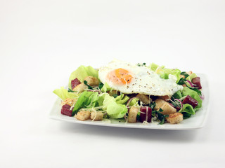 Salad with ham and fried egg
