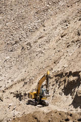 Fototapeta na wymiar Excavator or large backhoe be under construction a road