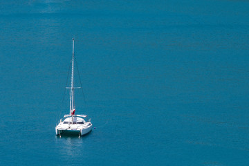 Fototapeta premium Aerial view of a catamaran sailing in the Andaman Sea, Phuket, Thailand