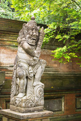 Traditional carved statue demon guards statue in Bali