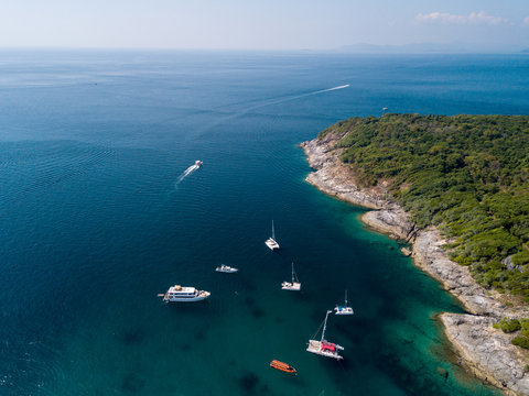 Aerial of cabin cruiser and yacht on the big ocean in Andaman take tourist goto snorkeling point at koh racha yai, Phuket, Thailand