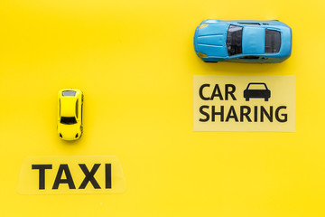 Carsharing vs taxi concept. Comparing carsharing system and taxi. Ship trip concept. Toy cars and...